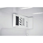 Ventilation grille on a white wall with lights above