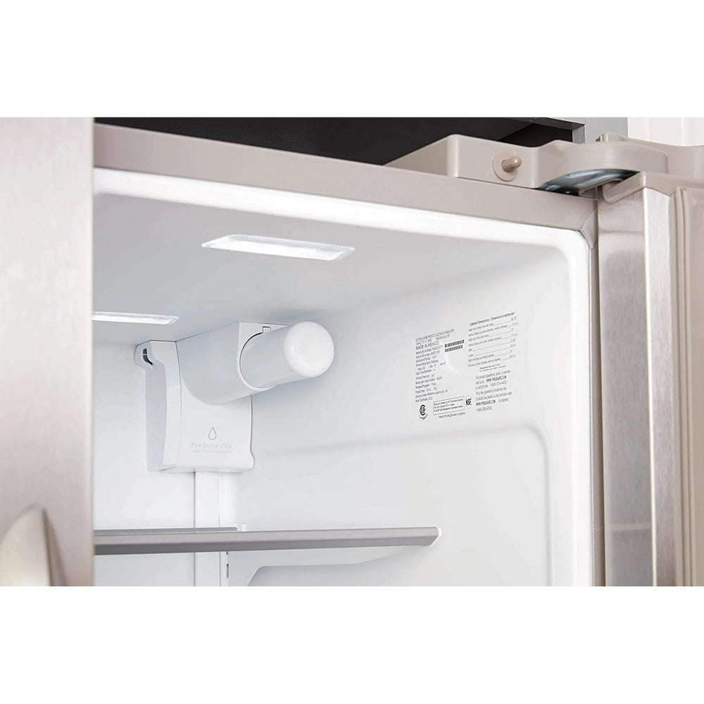 Close-up of a refrigerator interior with light on, showing shelves and a control panel.
